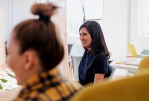 A woman laughing in an office