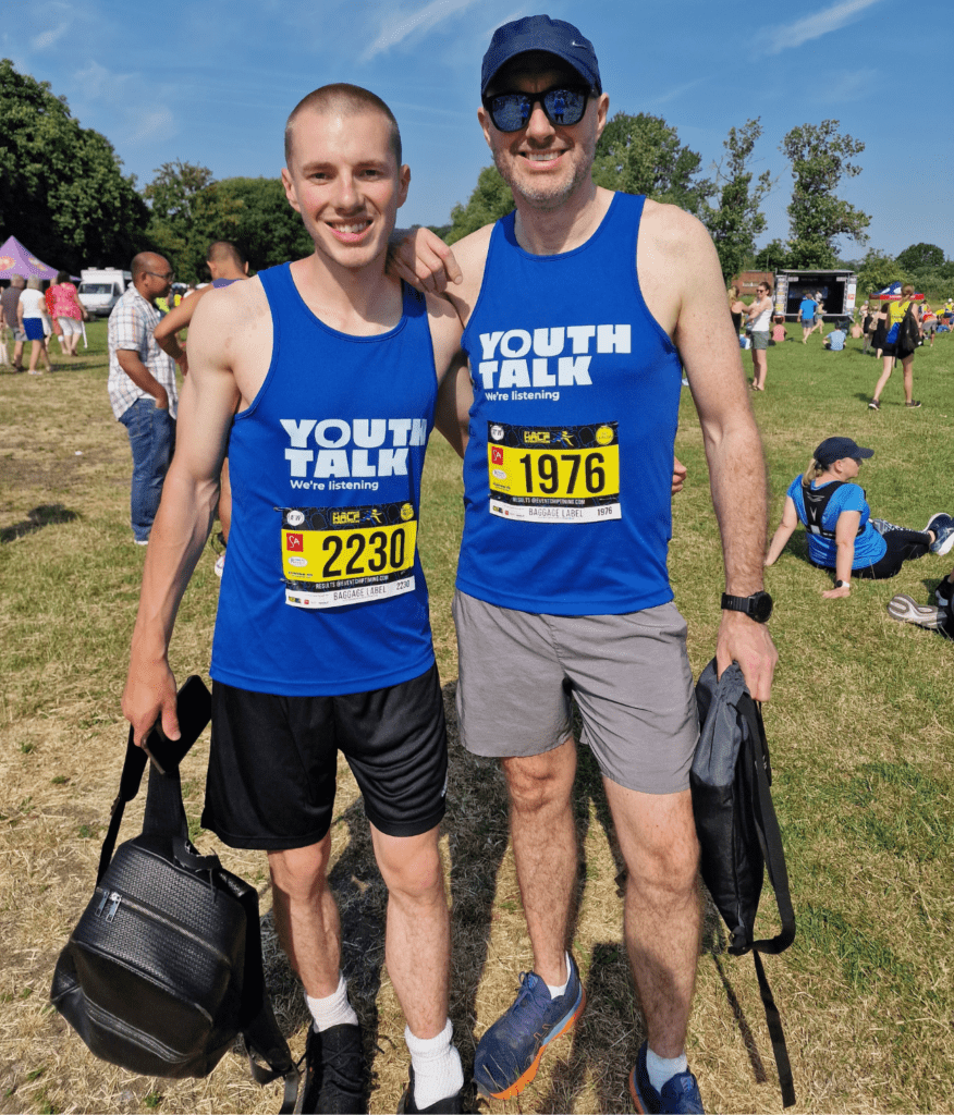 Luke and Lee during the St Albans Half Marathon wearing Youth Talk running vests.